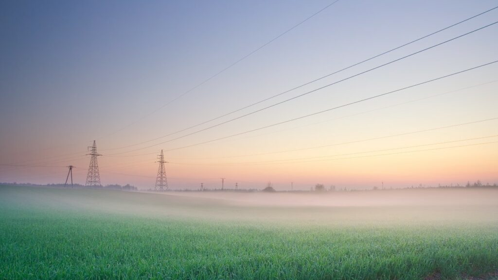 power-lines-on-field-in-morning-fog-SBI-300870330 sm